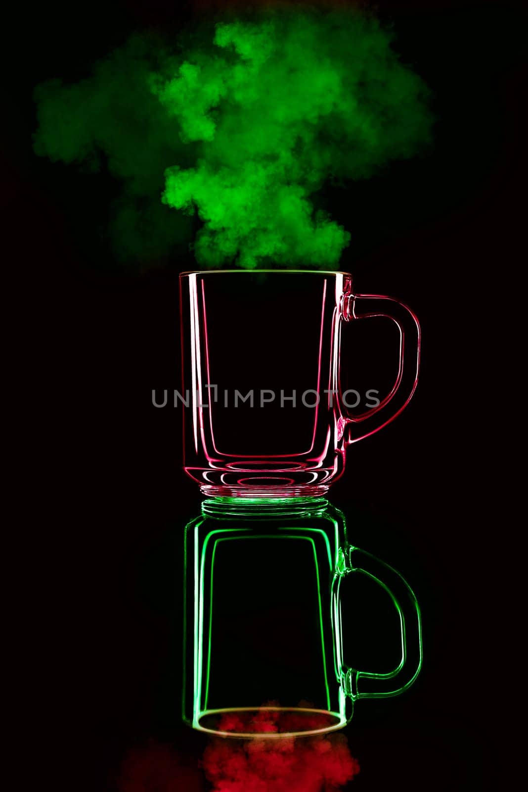 Just a glass on a black background with a reflection. Red and green, with steam. Isolated.