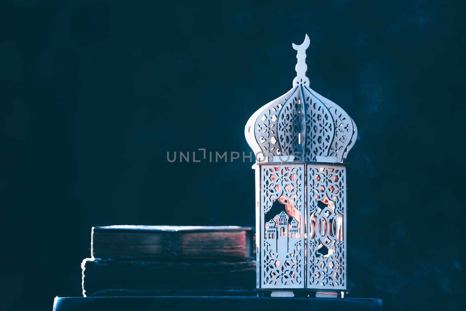 Ornamental Arabic lantern with with Holy Quran. Festive greeting card for Muslim holy month Ramadan Kareem.