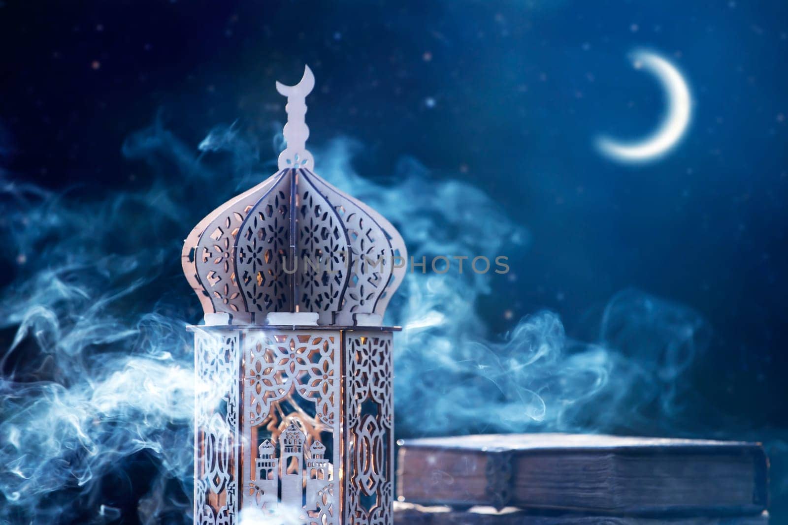 Ornamental Arabic lantern with crescent moon glowing at night. Festive greeting card for Muslim holy month Ramadan Kareem.