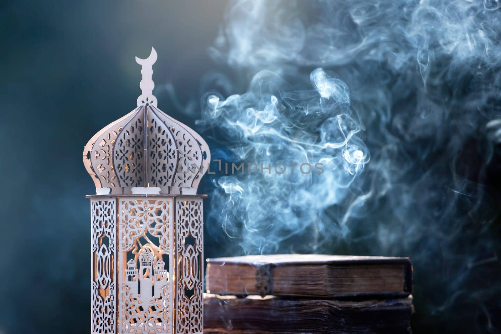 Ornamental Arabic lantern with with Holy Quran. Festive greeting card for Muslim holy month Ramadan Kareem.