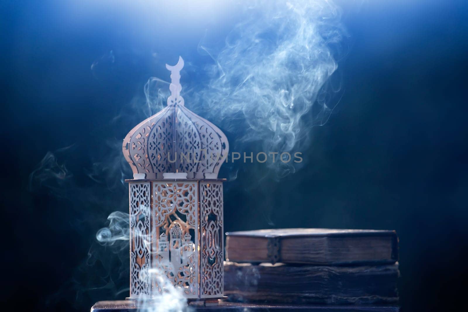 Ornamental Arabic lantern with with Holy Quran. Festive greeting card for Muslim holy month Ramadan Kareem.