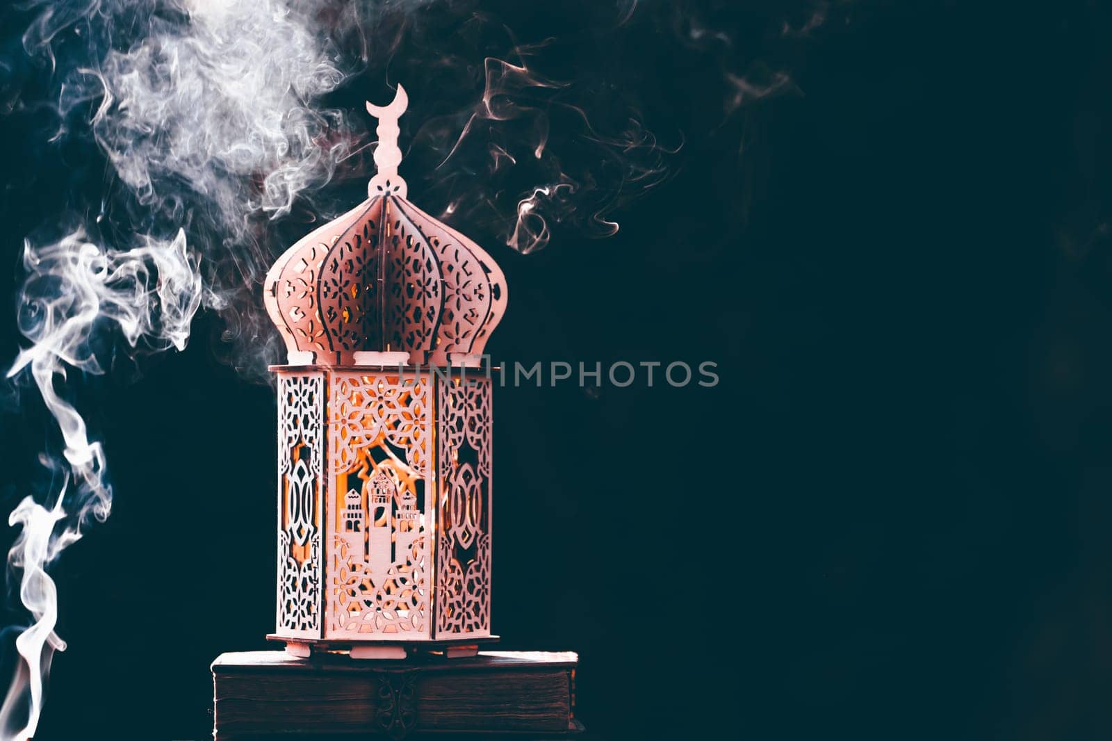 Ornamental Arabic lantern with with Holy Quran. Festive greeting card for Muslim holy month Ramadan Kareem.