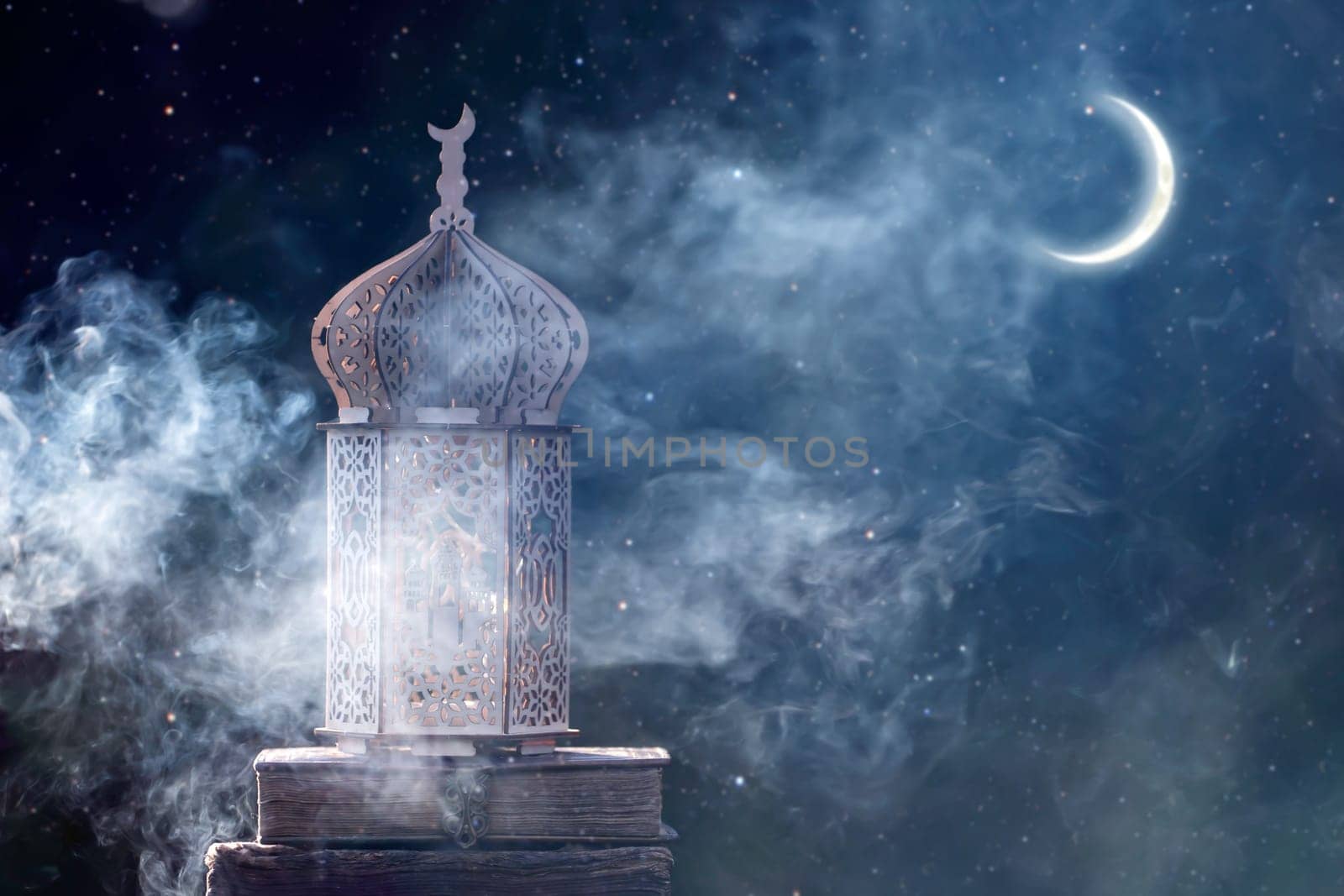 Ornamental Arabic lantern with crescent moon glowing at night. Festive greeting card for Muslim holy month Ramadan Kareem.