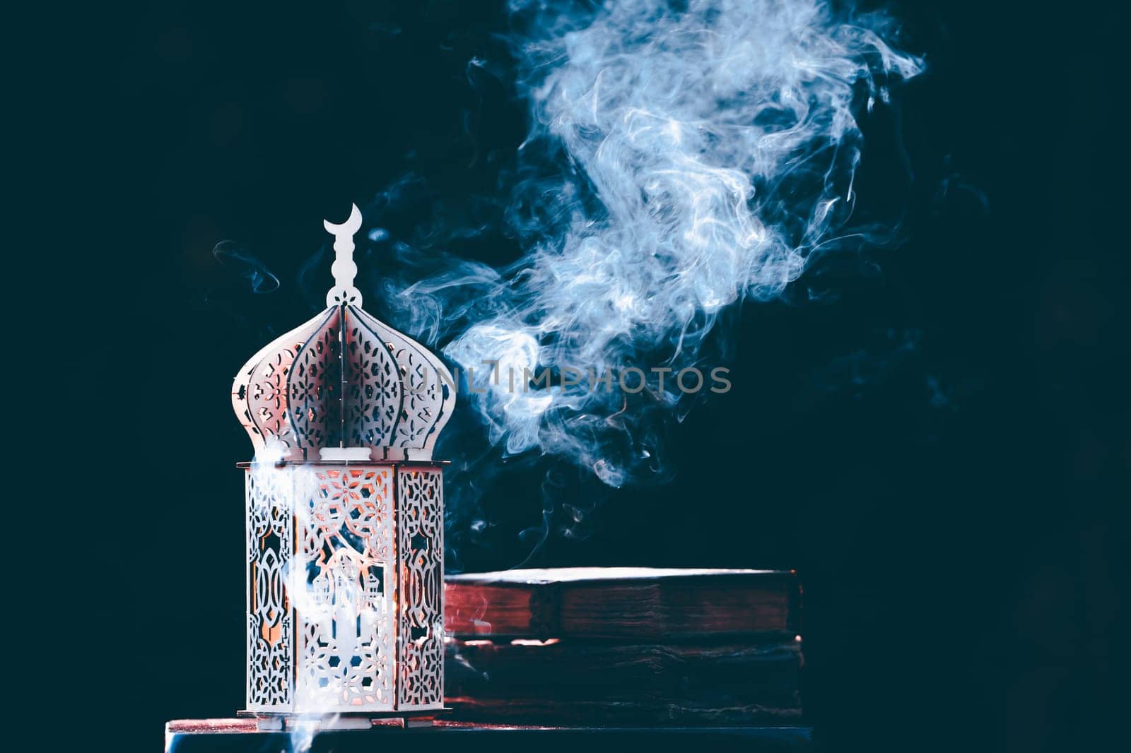 Ornamental Arabic lantern with with Holy Quran. Festive greeting card for Muslim holy month Ramadan Kareem.