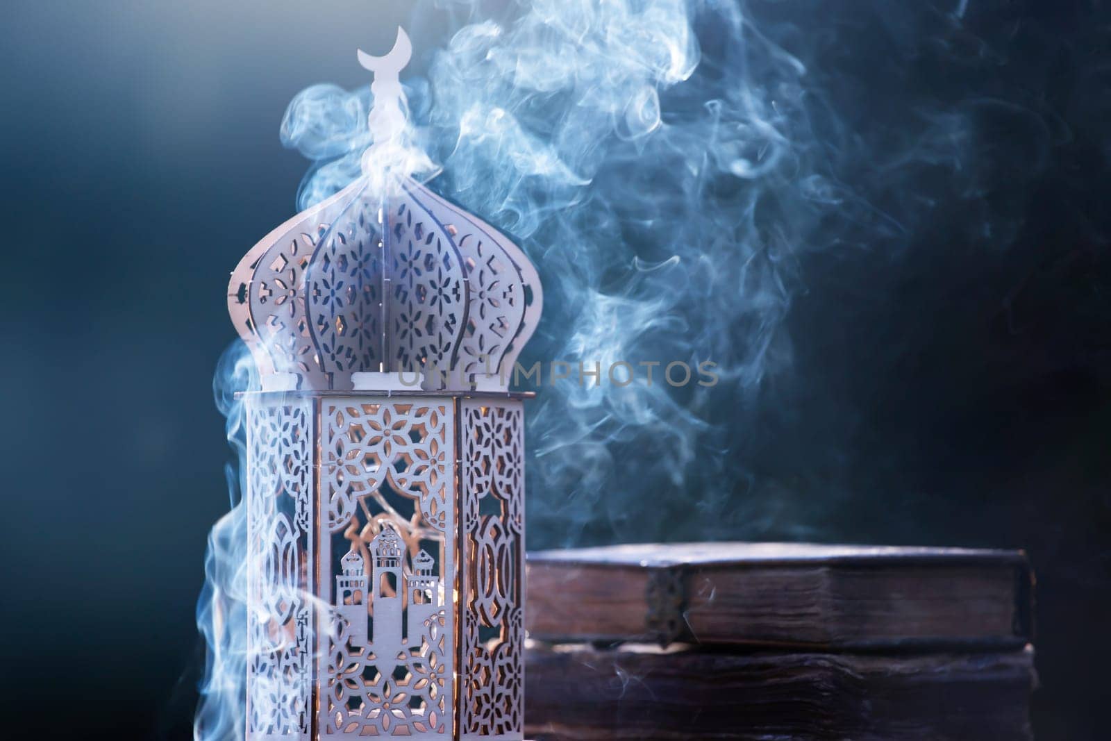 Ornamental Arabic lantern with with Holy Quran. Festive greeting card for Muslim holy month Ramadan Kareem.