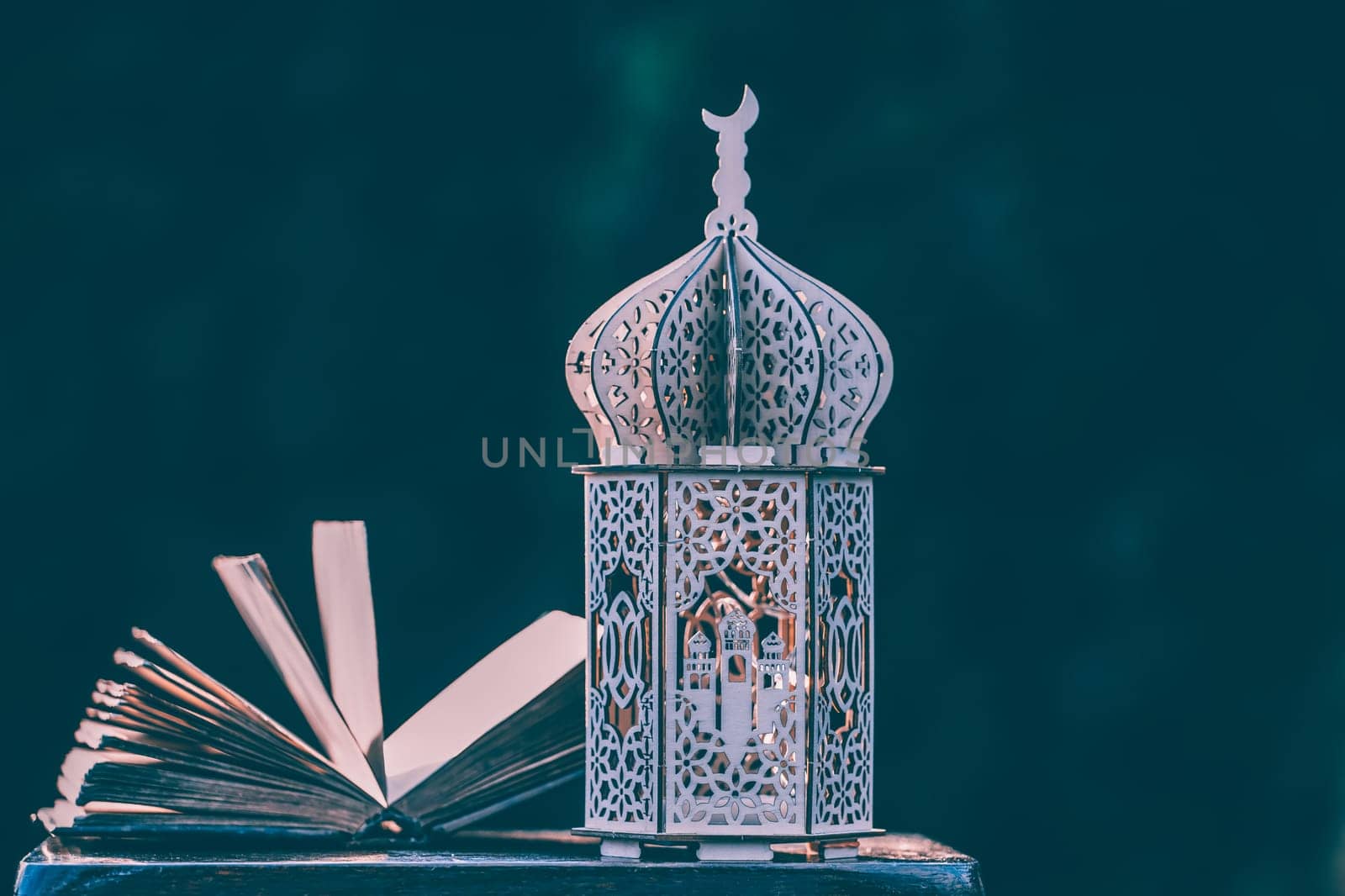 Ornamental Arabic lantern with with Holy Quran. Festive greeting card for Muslim holy month Ramadan Kareem.