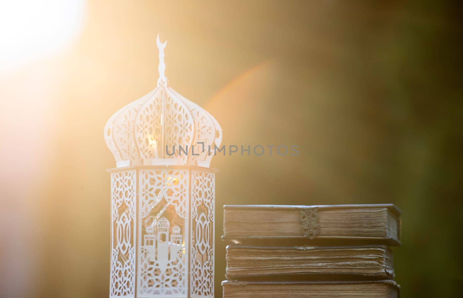 Ornamental Arabic lantern with with Holy Quran. Festive greeting card for Muslim holy month Ramadan Kareem.