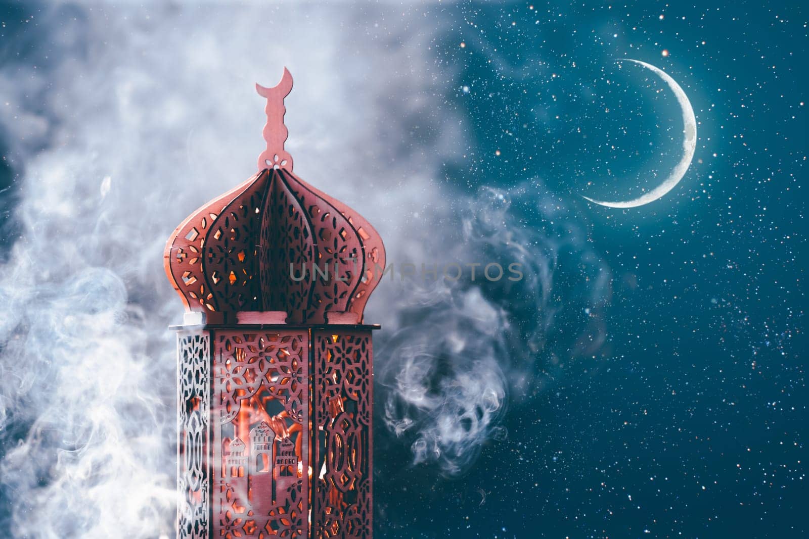 Ornamental Arabic lantern with crescent moon glowing at night. Festive greeting card for Muslim holy month Ramadan Kareem.