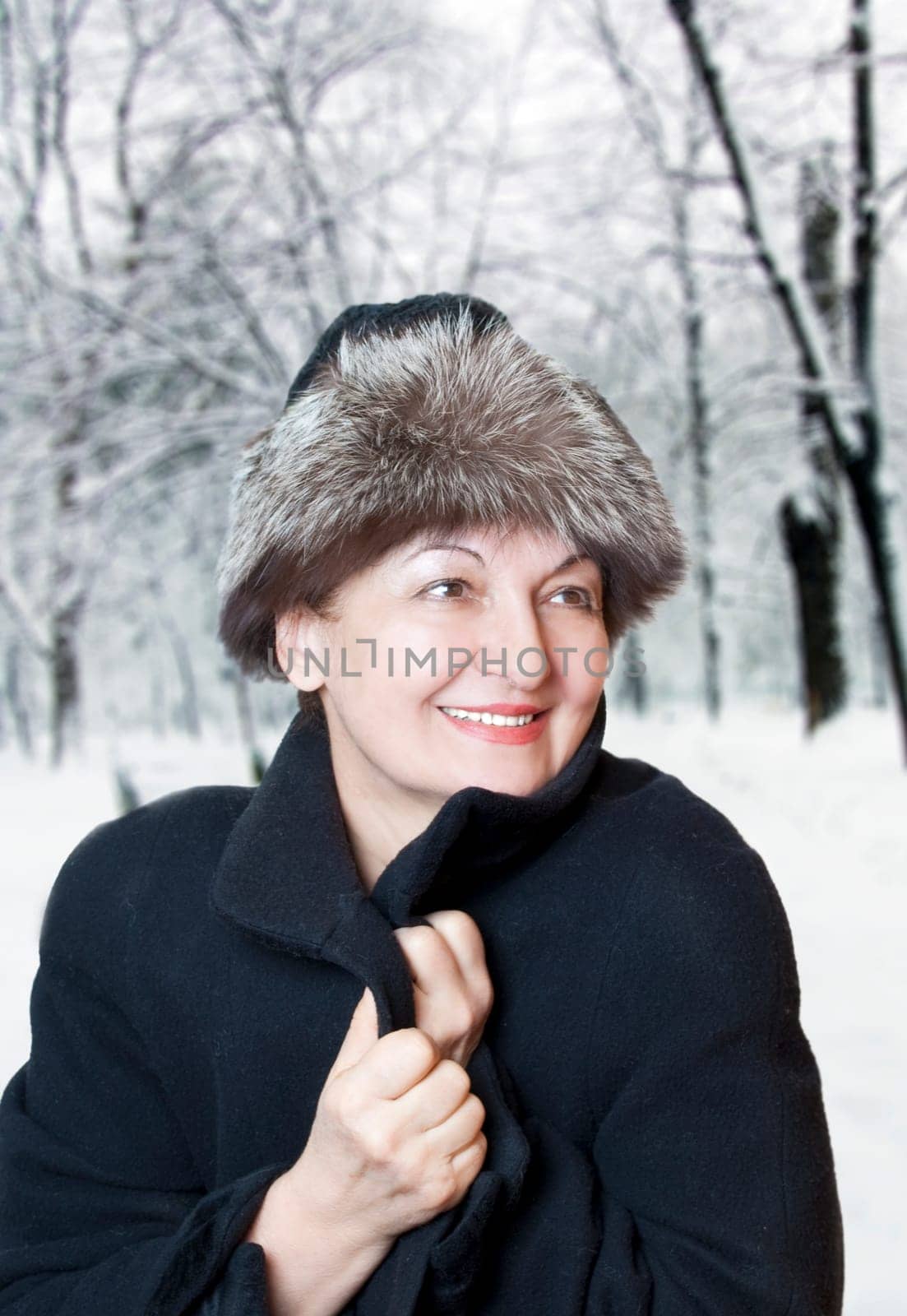 Happy elderly woman enjoy the winter