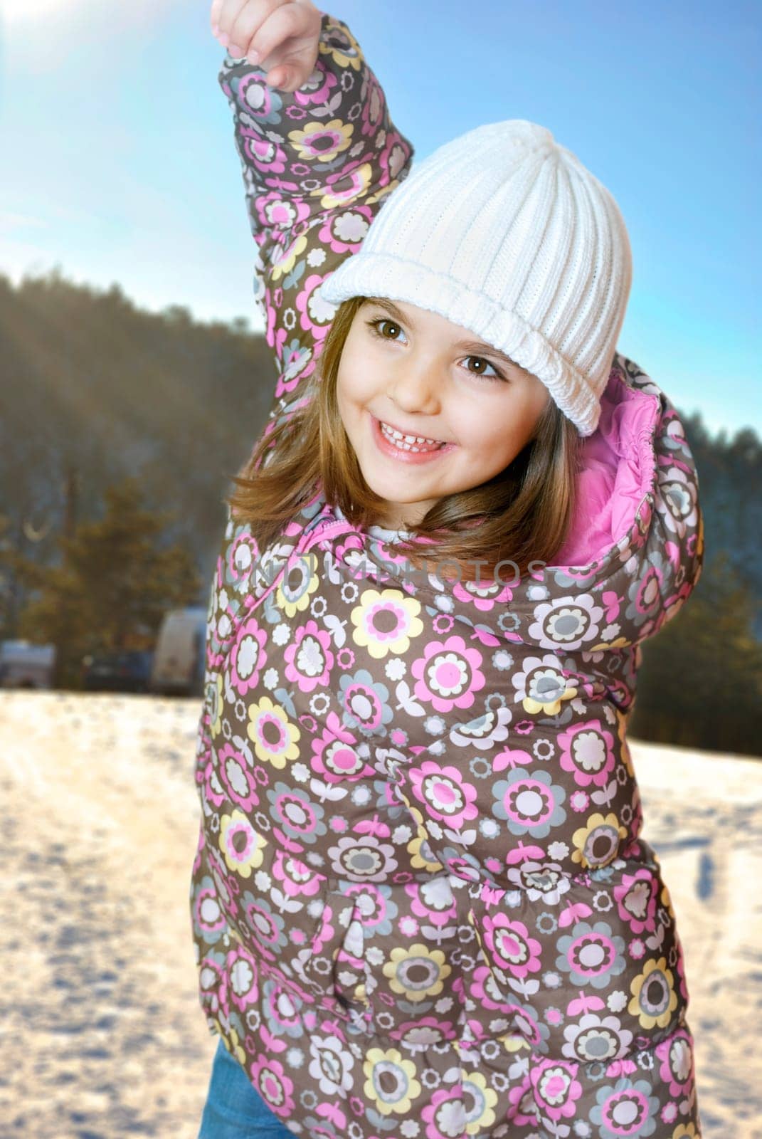 Happy little girl playing in snow