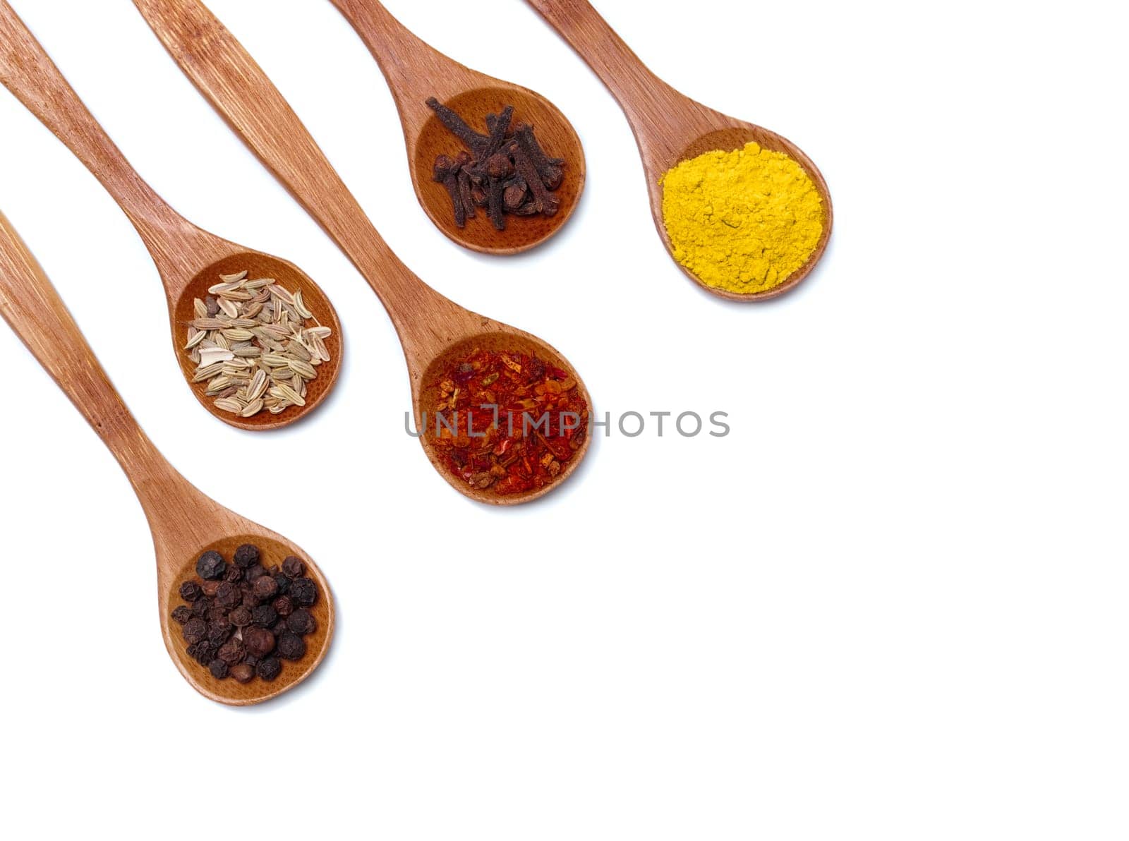 Various of spices in wooden spoon isolated over white