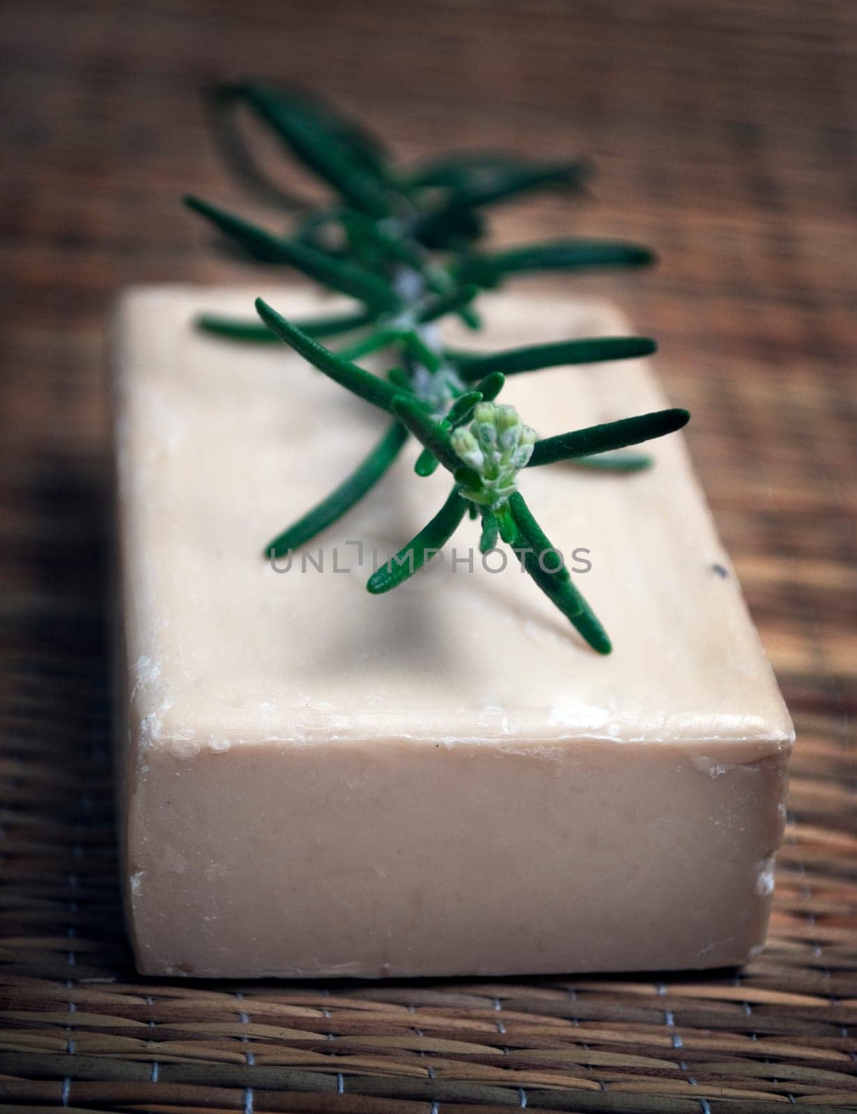 Bar of natural soap with fresh rosemary