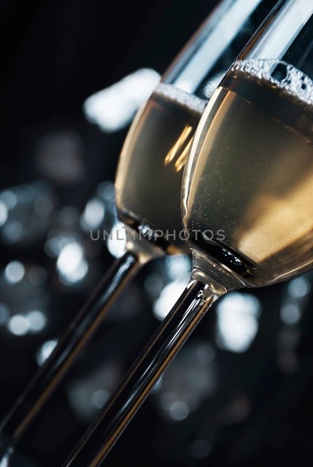 two glasses of champaign in font of the night lights