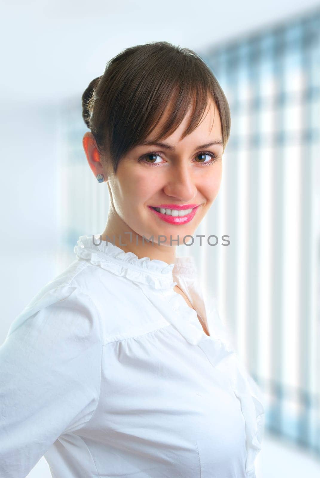 Portrait of a young attractive business woman in office