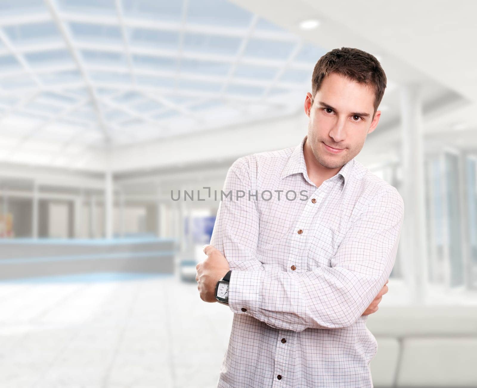 Young attractive businessman isolated over white