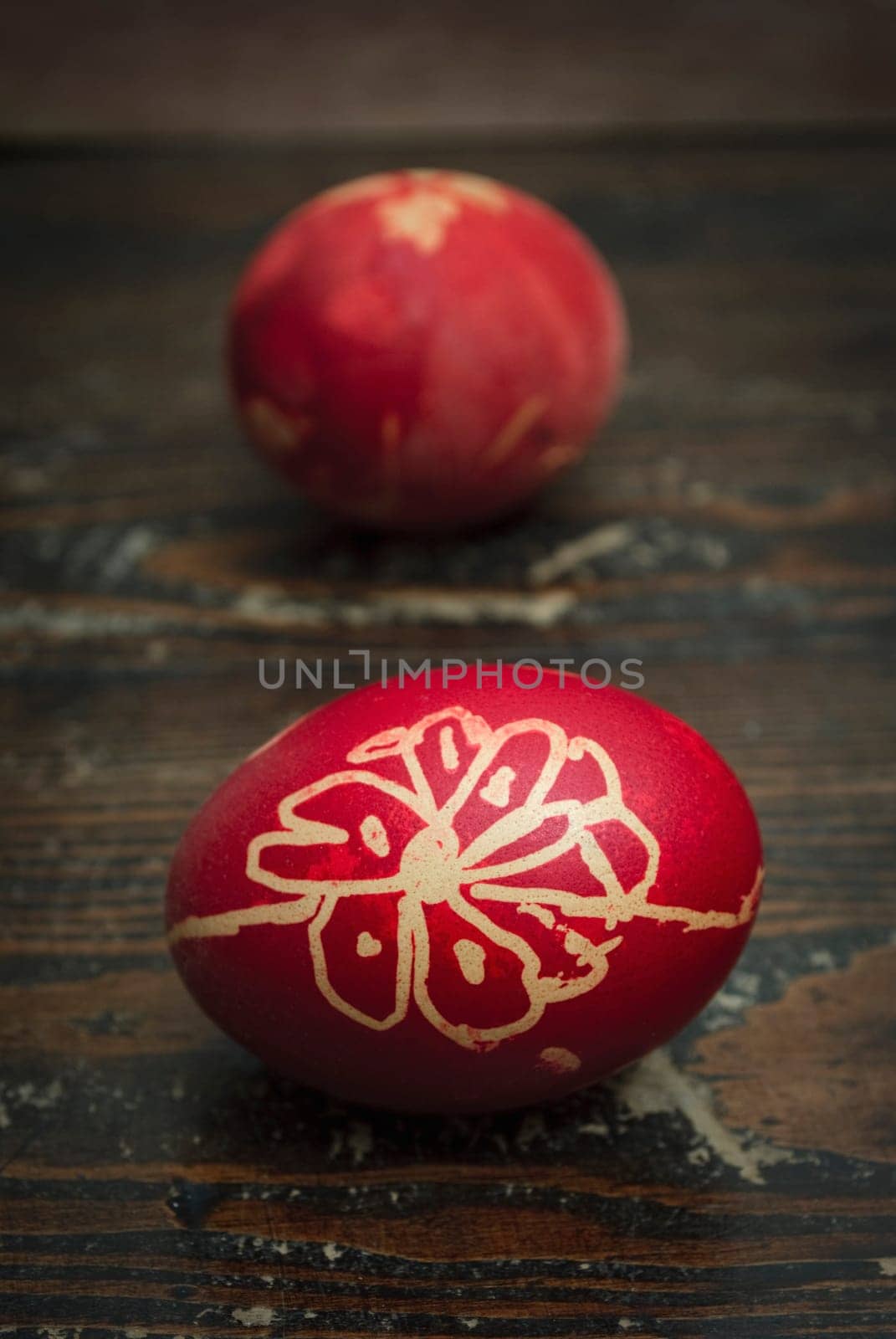 Red easter eggs on wooden plank
