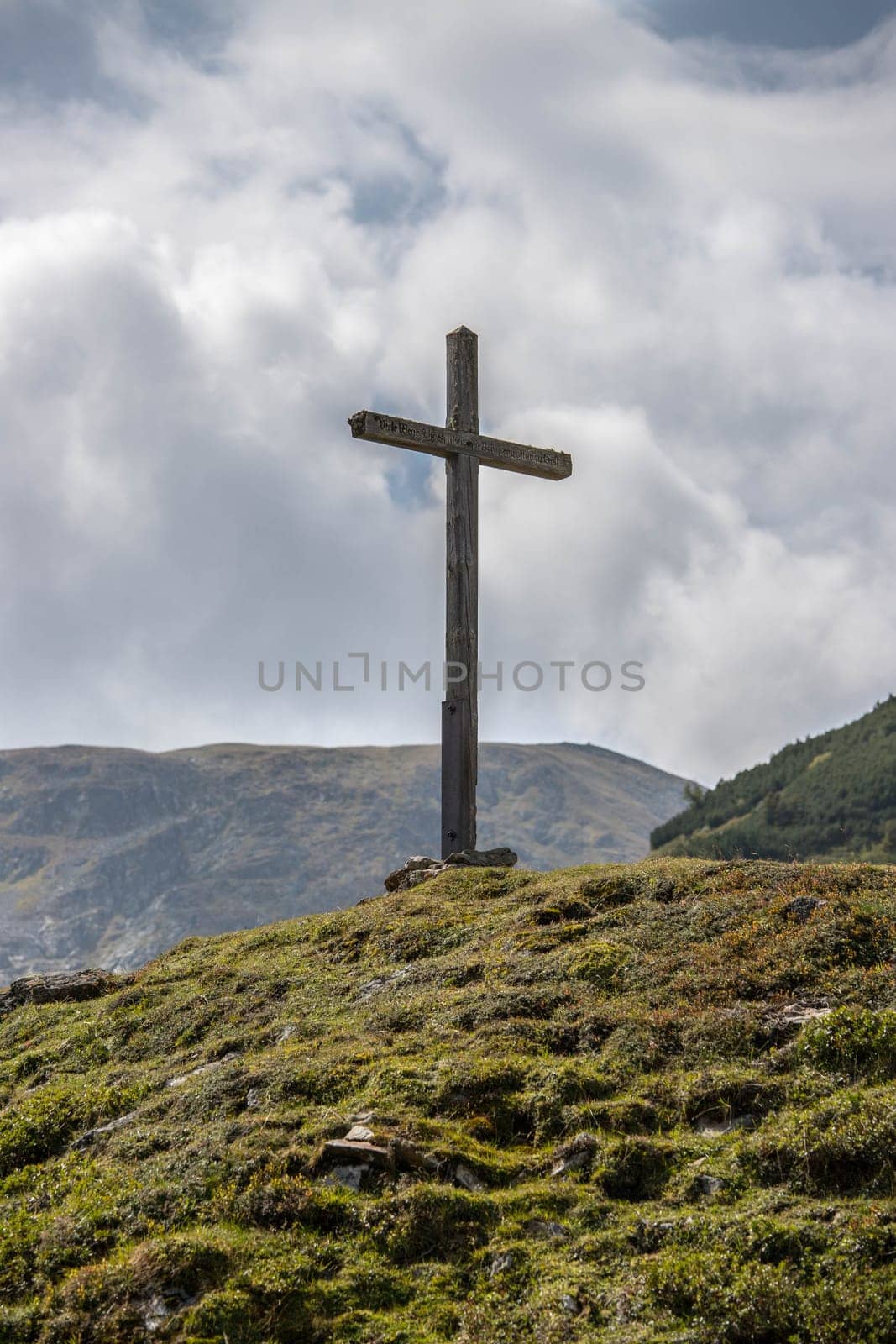 Peak with wooden summit cross in the Austrian mountains