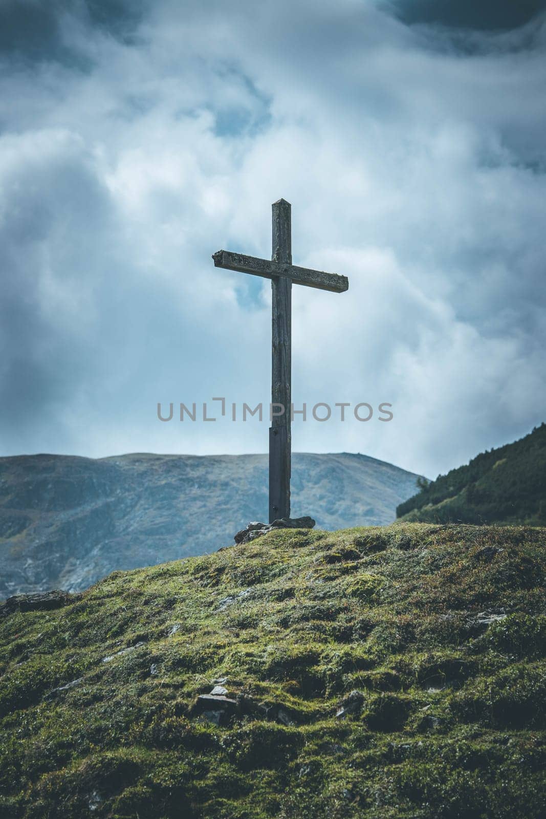 Peak with wooden summit cross in the Austrian mountains