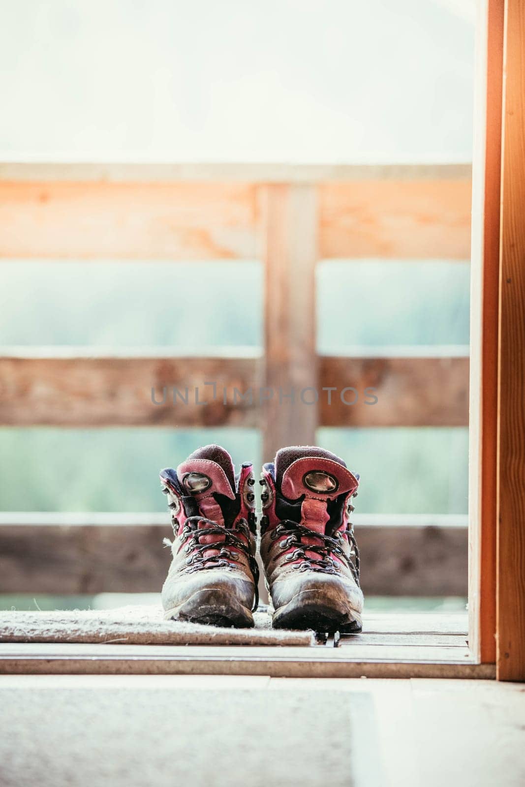 Hiking boots on rustic wood floor in an abandoned mountain chalet in Austria