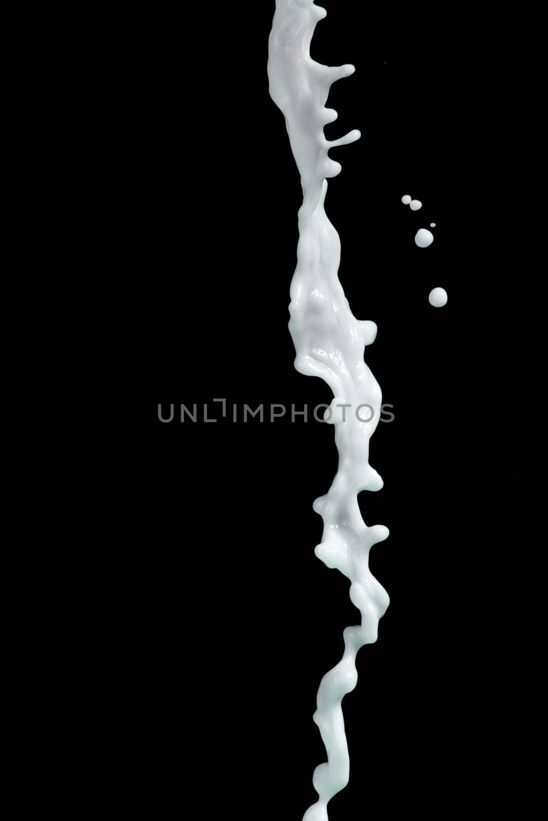 milk or white liquid splash on black background