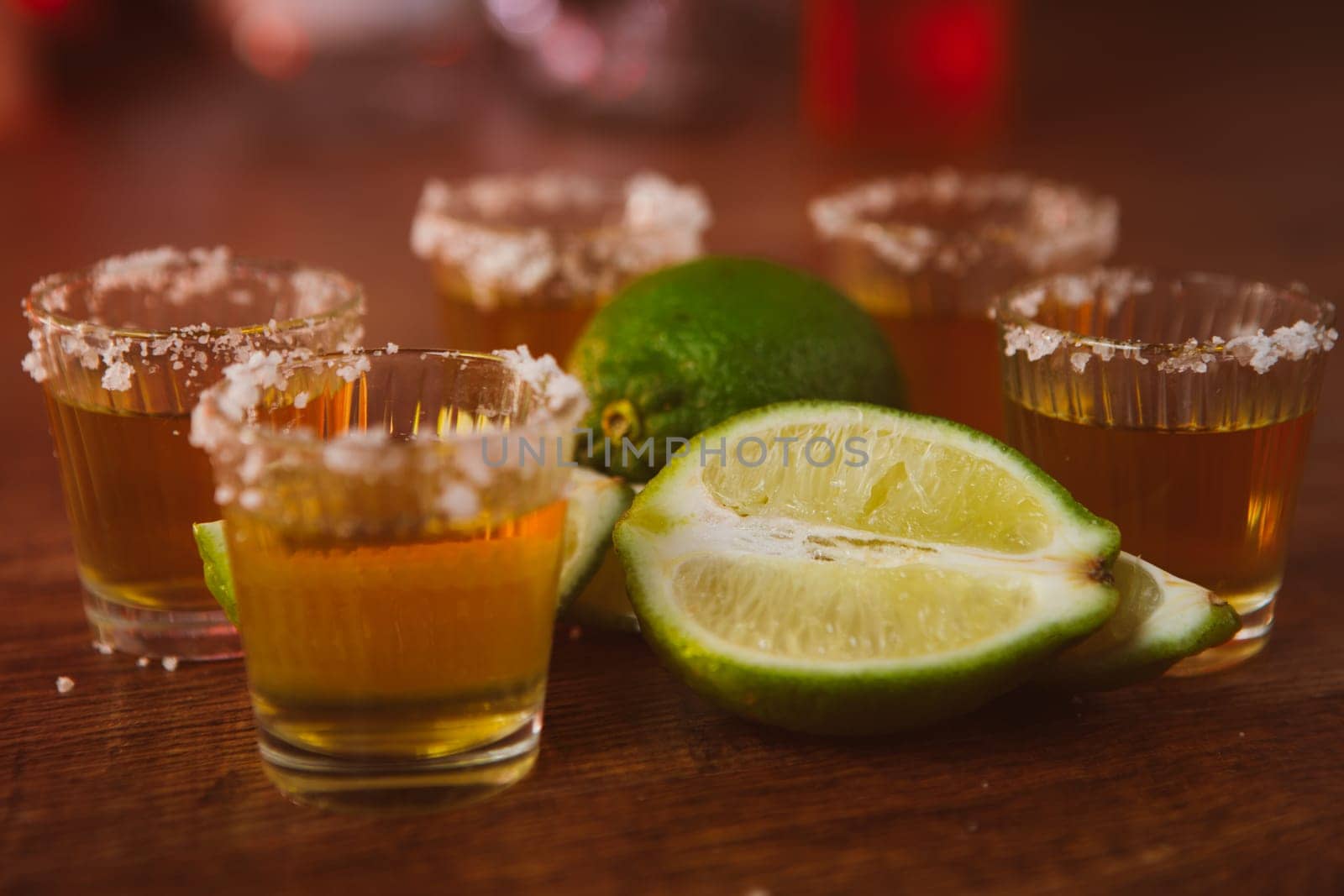 tequila , lime and salt on wooden table selective focus