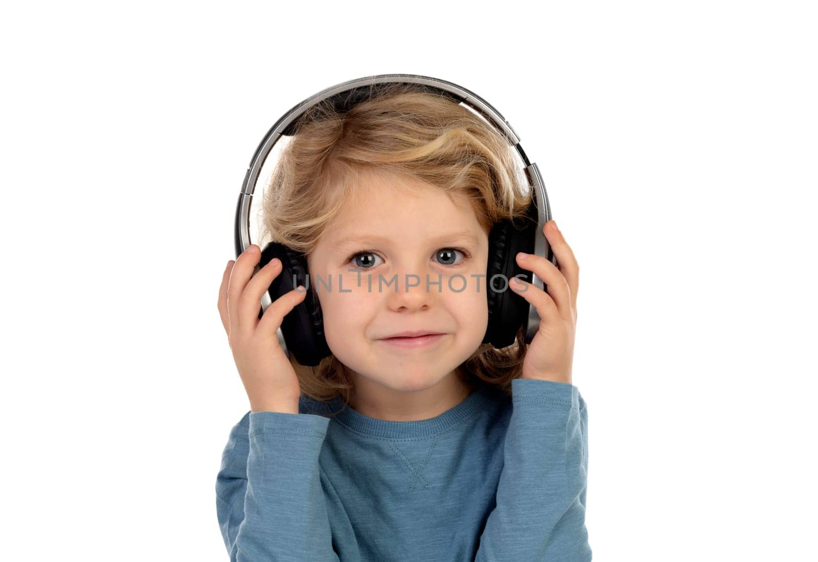 Happy blond child with headphones an blue t-shirt isolated on a white background