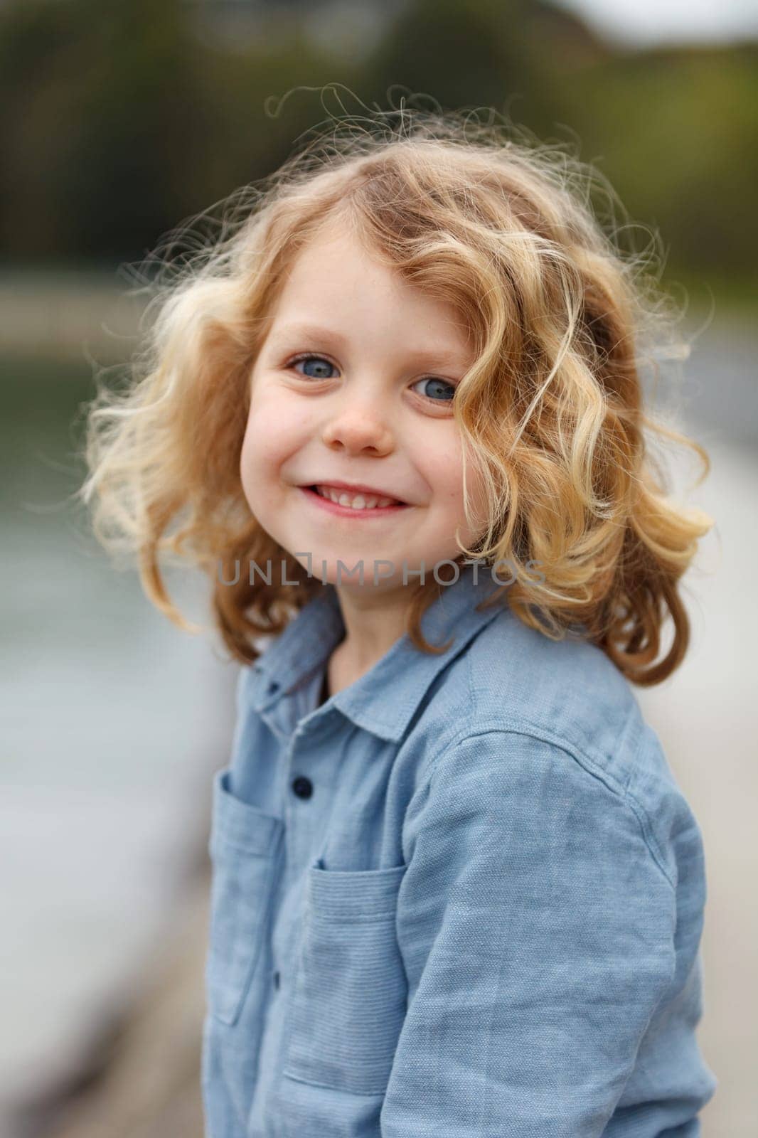 Happy small child with long blond hair enjoying the holidays
