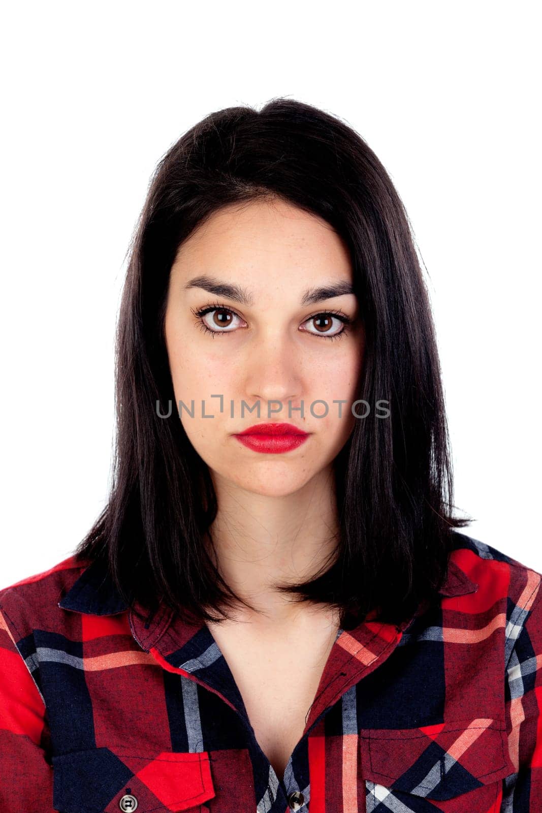 Serious brunette girl with red plaid shirt isolated on a white background