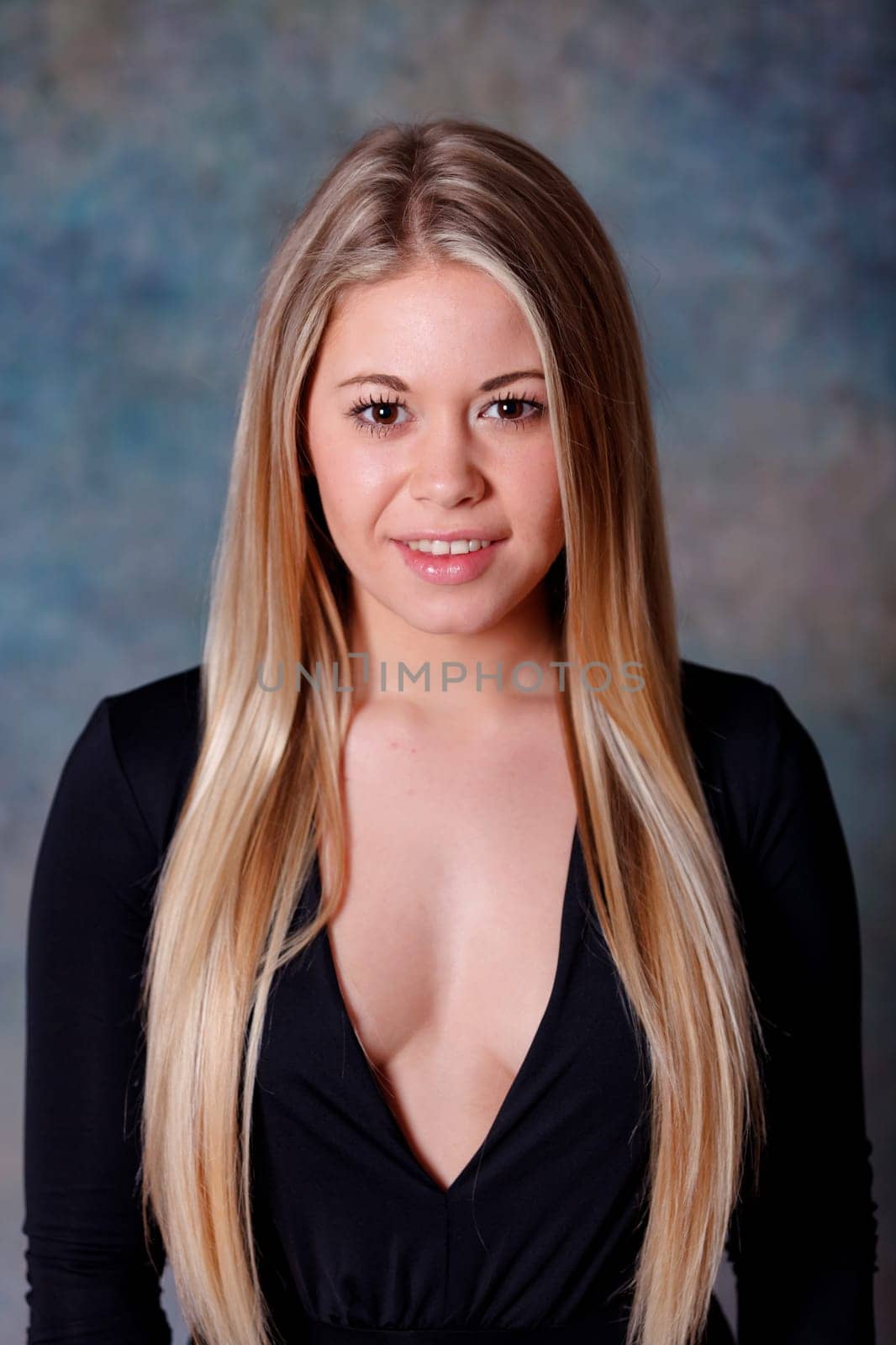 Pretty girl with long blond hair and blue background