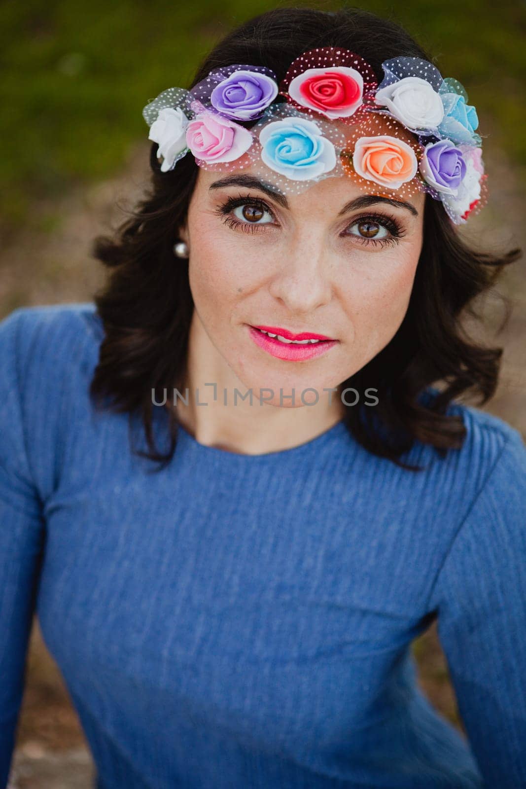 Pretty brunette girl with flower crown in the park