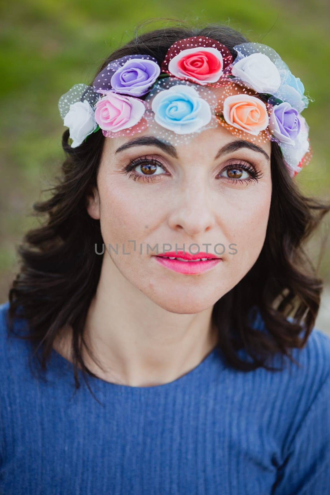 Pretty brunette girl with flower crown in the park