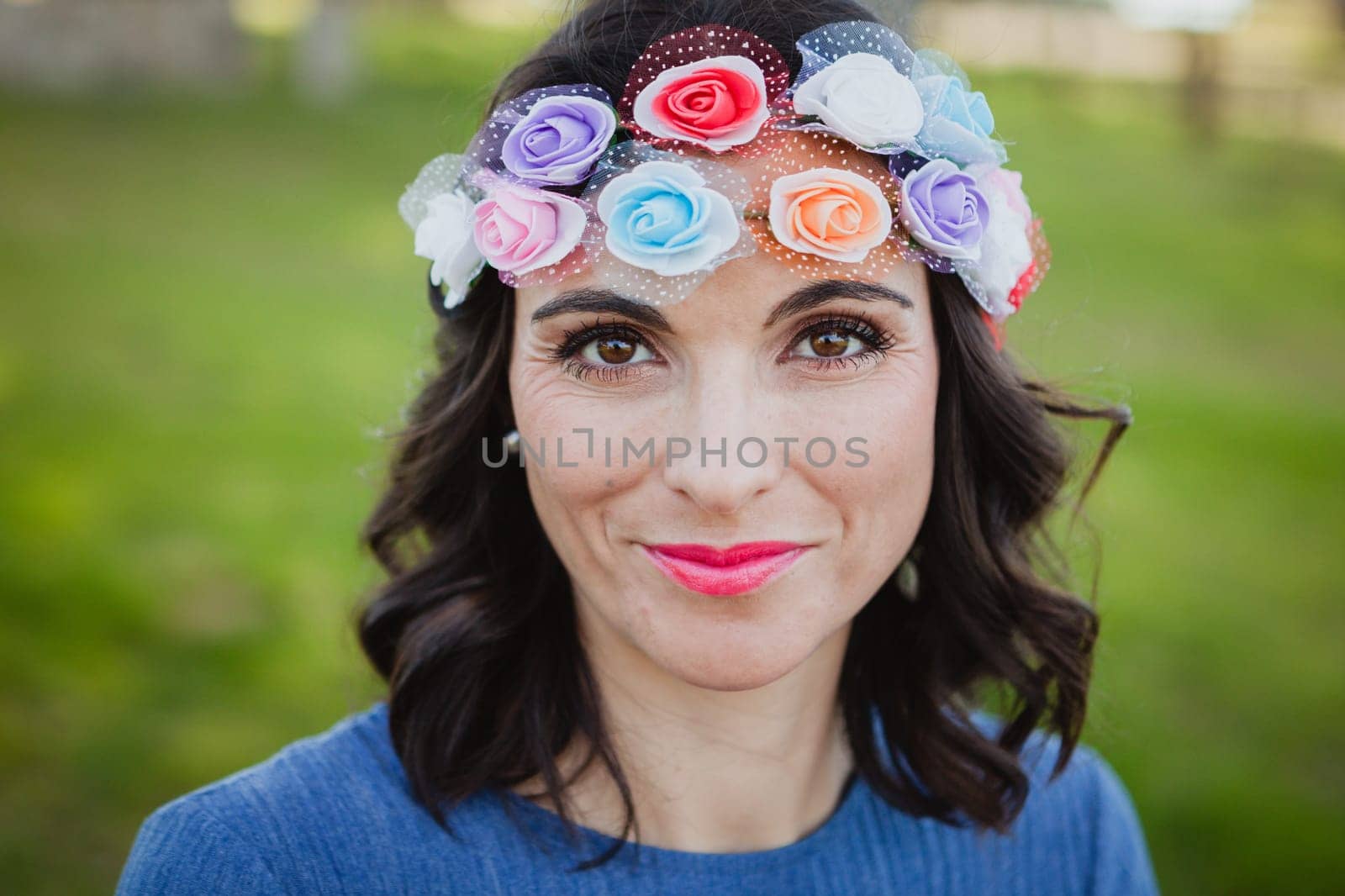 Pretty brunette girl with flower crown in the park