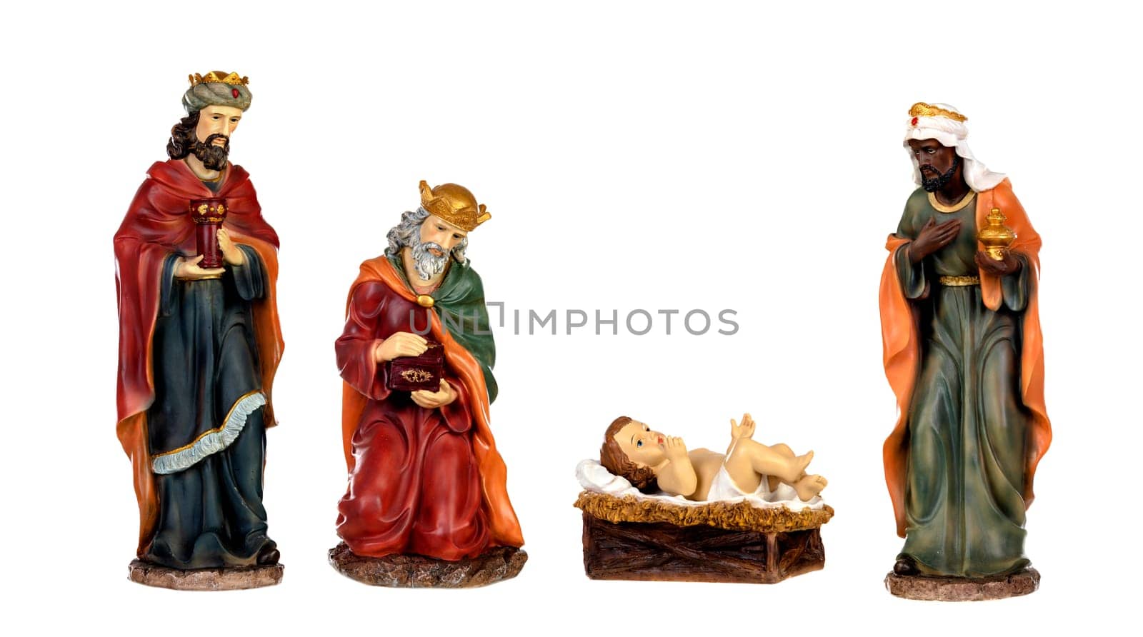 The three wise men and baby Jesus. Ceramic figures isolated on white background