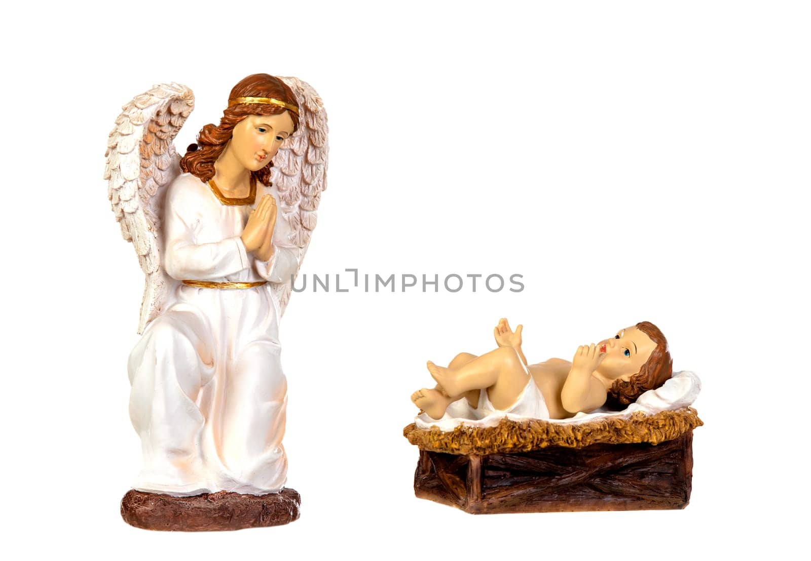 Ceramic figure of The Baby Jesus and the angel of the nativity scene isolated on a white background