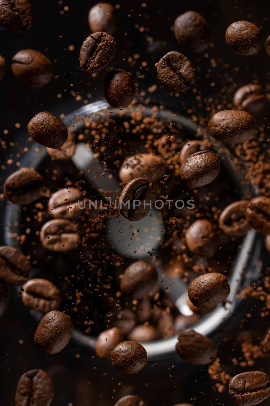 Ground coffee beans flying from a coffee grinder