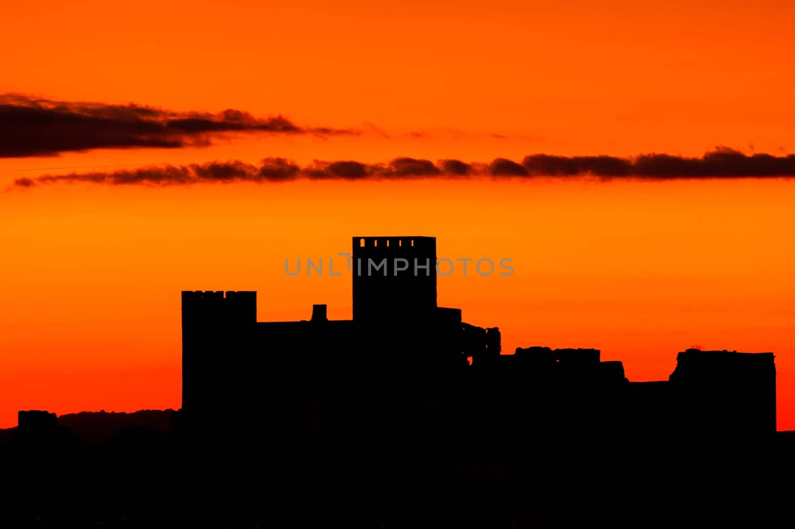 Silhouette of a amazing castle over a red sky