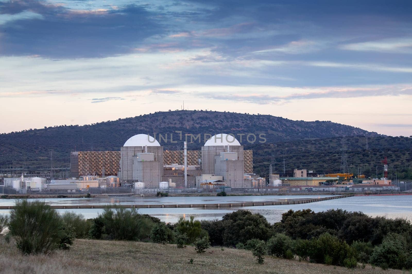 Almaraz, nuclear power plant in the center of Spain, surrounded by a green field