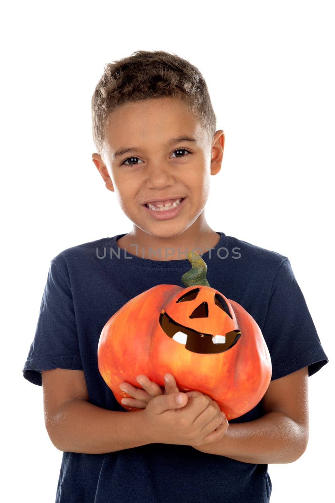 Happy latin boy holding a big pumpkin isolated on a white background