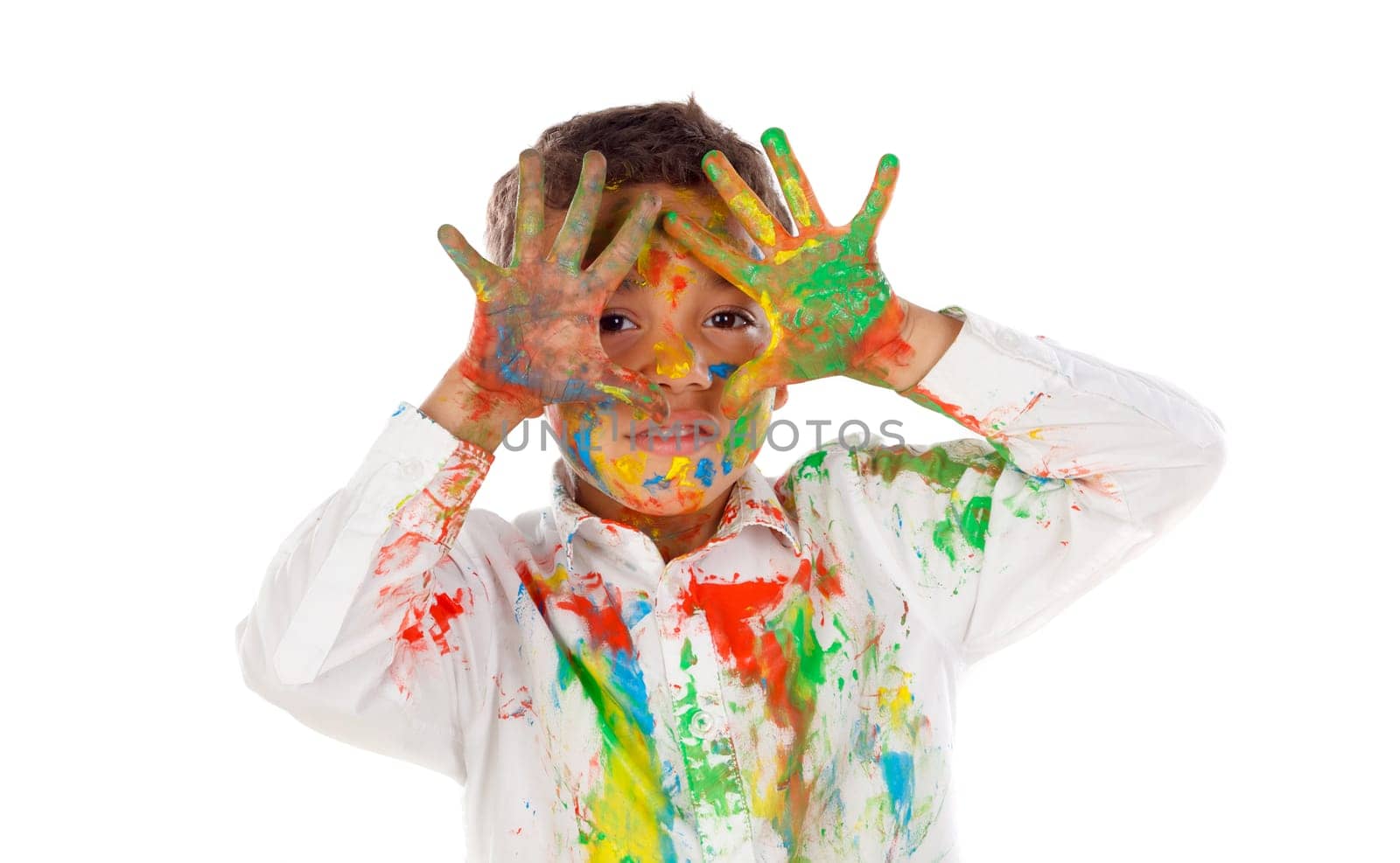 Funny boy with hands and face full of paint isolated on a white background