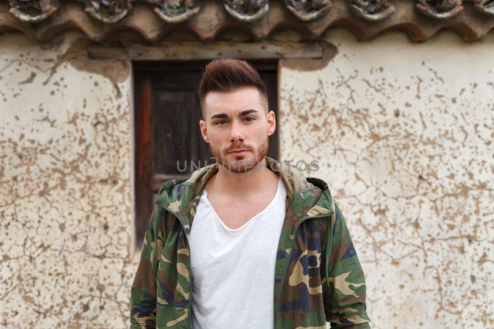 Atractive guy with jacket with military stylish in a vintage house