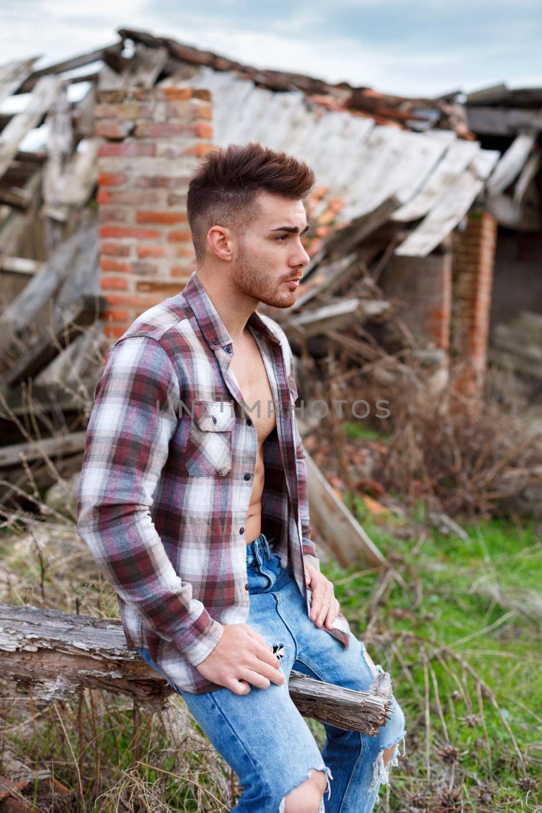 Attractive guy with the plaid shirt unbuttoned