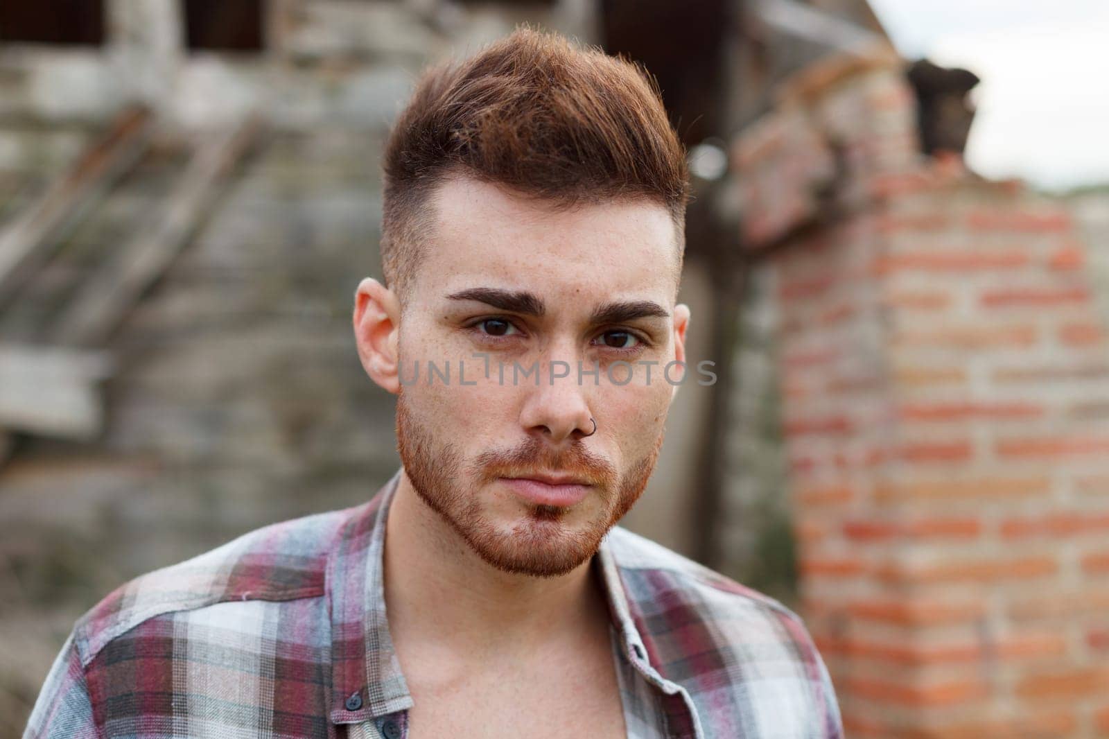 Attractive guy with the plaid shirt unbuttoned