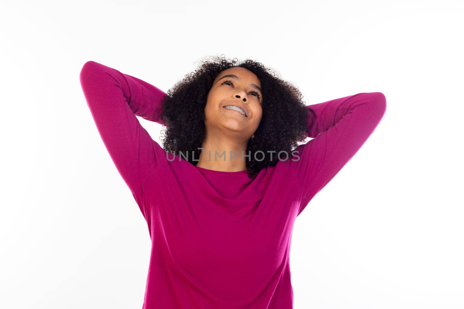 Beautiful teenager girl with pink sweater isolated on a white background