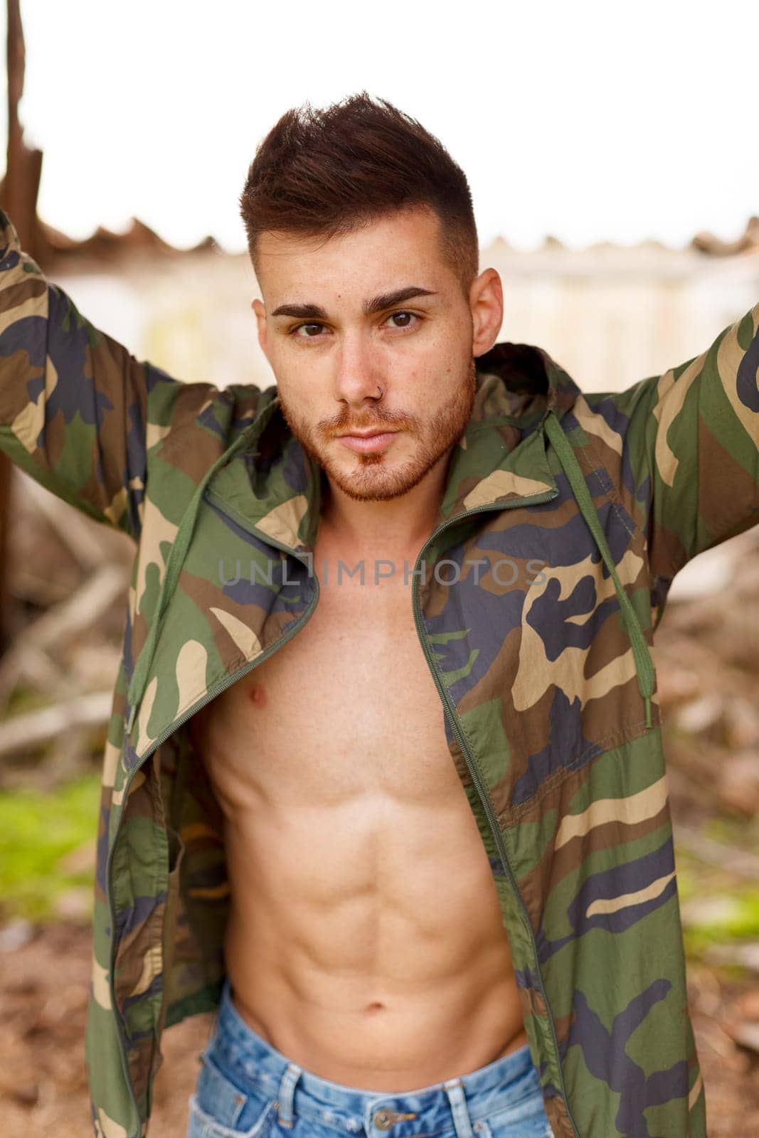 Fashion guy with green jacket looking at camera