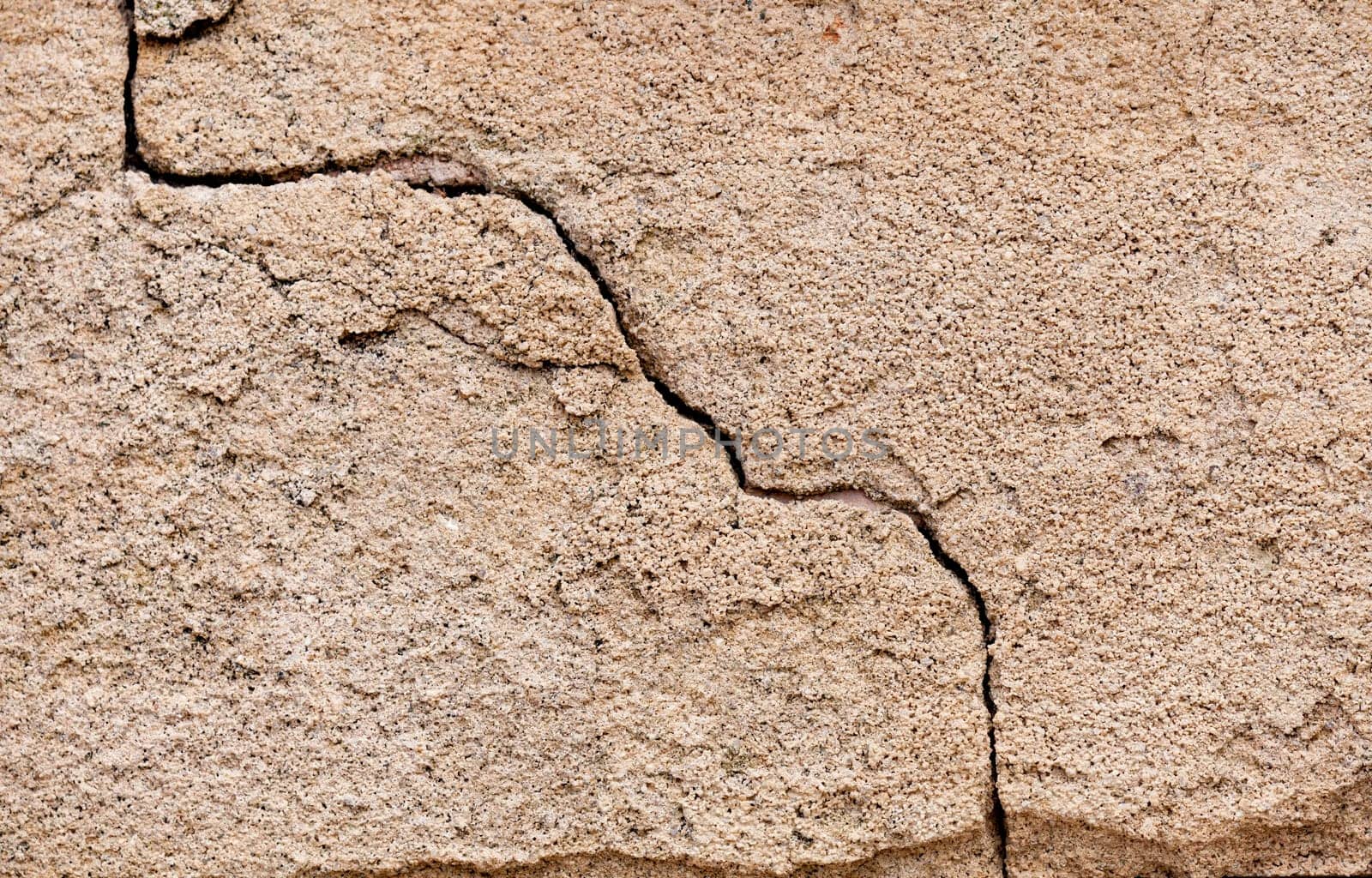 Crack in a wall on a cement surface