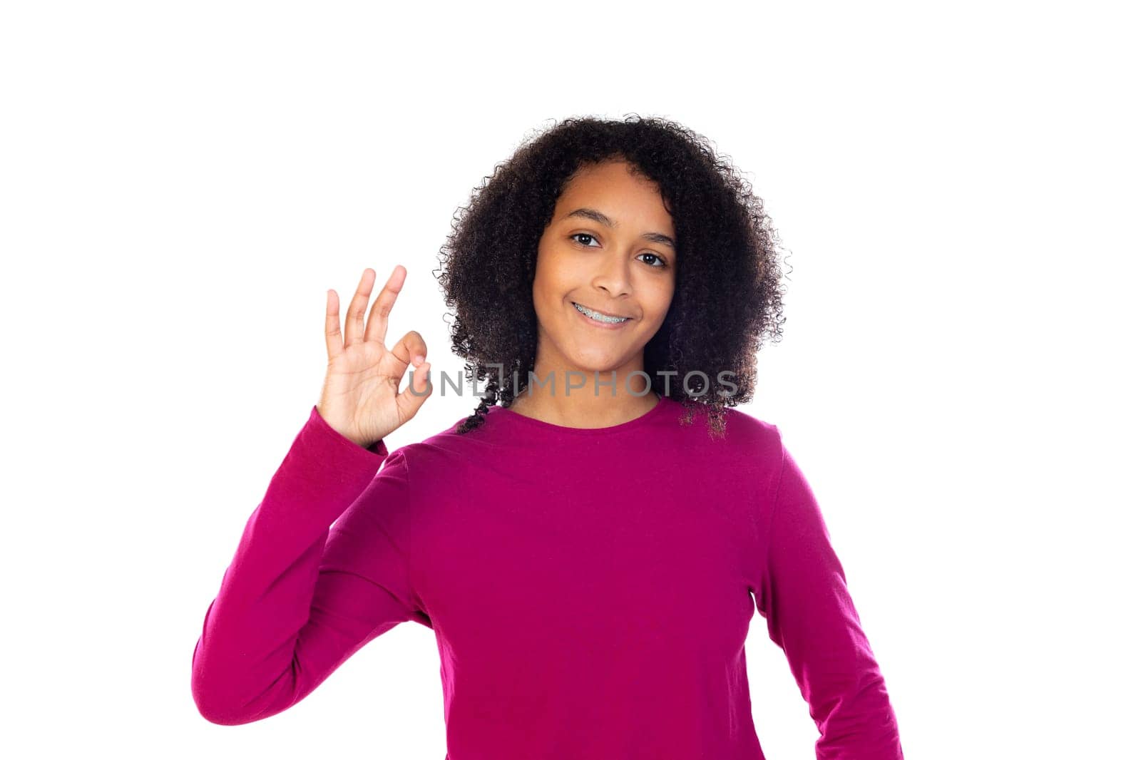 Beautiful teenager girl with pink sweater isolated on a white background
