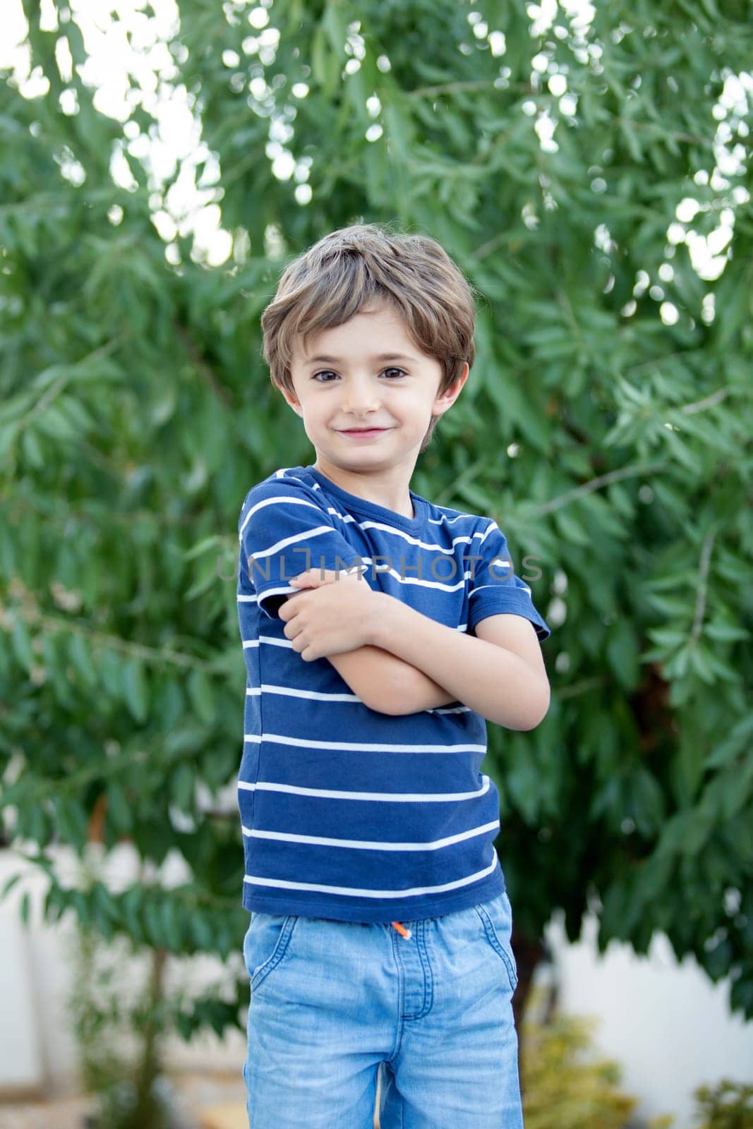 Adorable small child in the field looking at camera