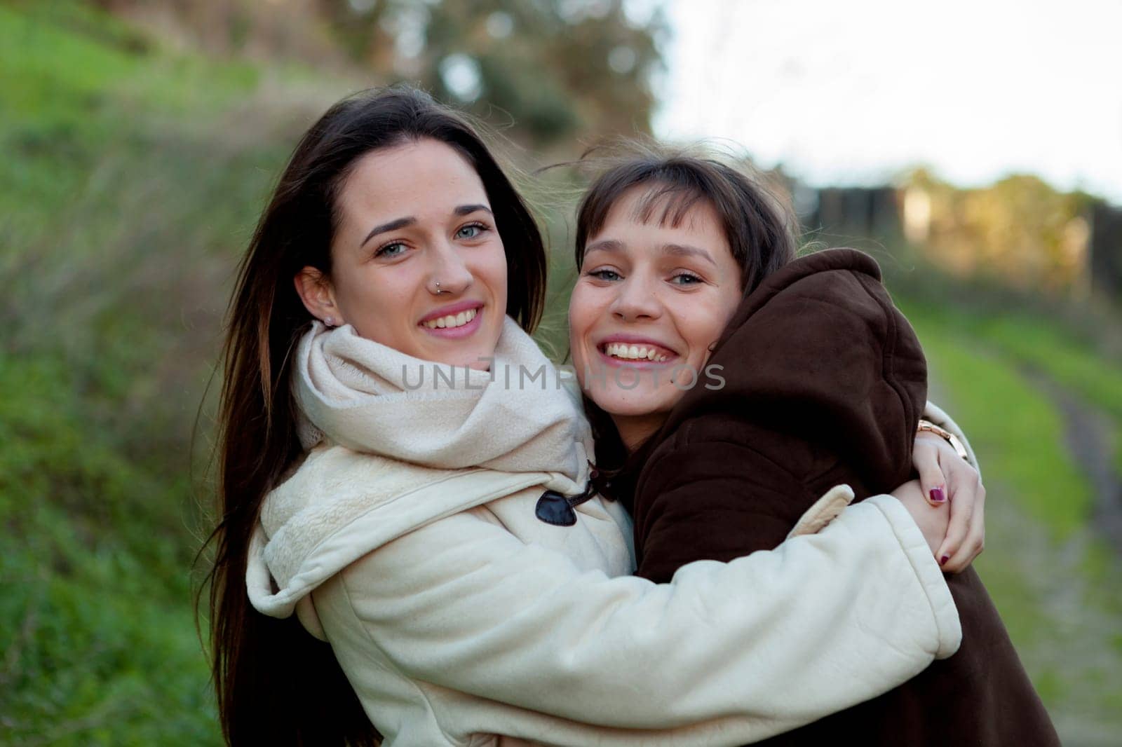 Nice sisters with blue eyes in a park