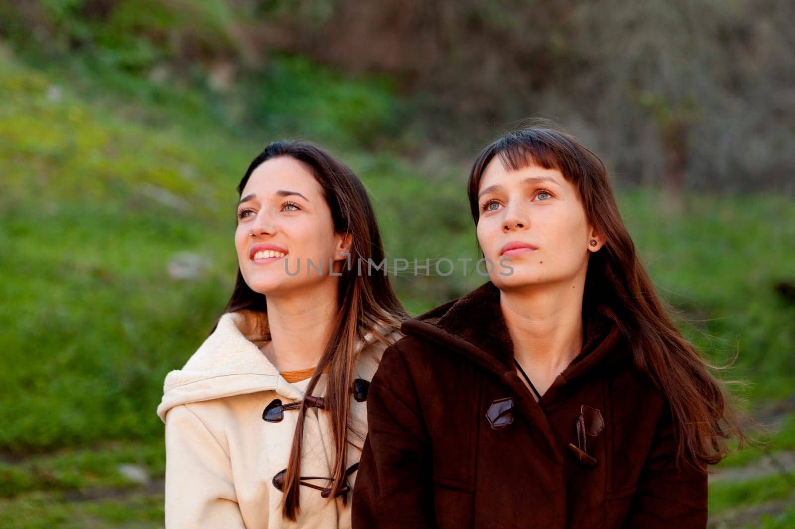 Nice sisters with blue eyes in a park