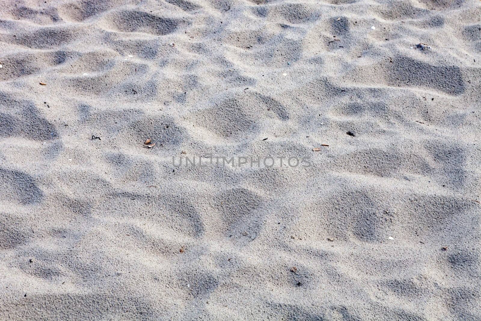 Closeup sand of beach in the summer for background